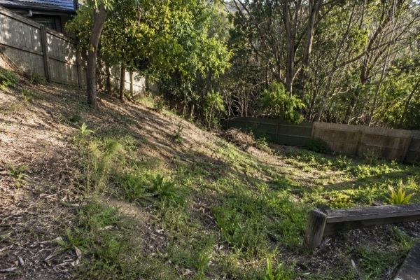 Sloping unstable backyard in Sydney before a retaining wall was built