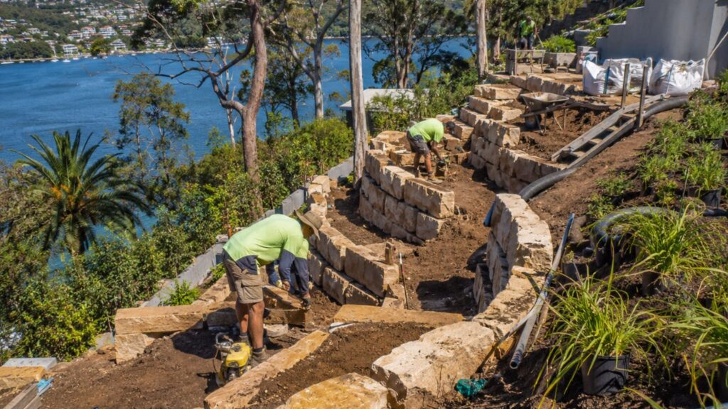 Crew working a steep access Northern Beaches block mid-project